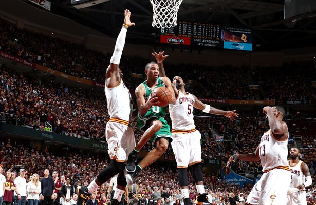 Avery Bradley von den Boston Celtics wird im NBA-Spiel von drei Gegenspielern beim Korbleger gestört.